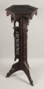 A 19TH CENTURY MOORISH CARVED HARDWOOD STAND, hand-carved with floral decoration, with three