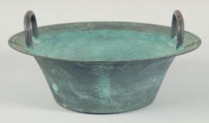 A CHINESE METAL TWIN HANDLE CIRCULAR BOWL, the interior centre with dragons and characters, 30cm