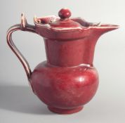 A CHINESE MING STYLE COPPER RED MONKS EWER, and cover, base with six-character mark, 20cm high.
