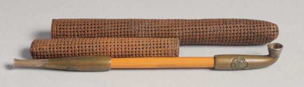 A JAPANESE TOBACCO PIPE, with metal mounts, together with a woven case, pipe 19.5cm long.