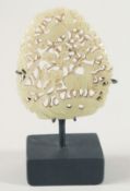 A SUPERB CHINESE CARVED AND PIERCED JADE PLAQUE, with display stand, the plaque depicting a crane