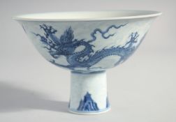A CHINESE BLUE AND WHITE PORCELAIN STEM CUP, the exterior of the bowl painted with dragons, the