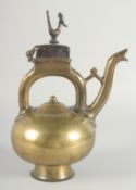 AN ISLAMIC BRONZE EWER, the handle with peacock finial, inscribed, 31cm high.