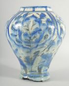 A 17TH/18TH CENTURY PERSIAN BLUE AND WHITE GLAZED POTTERY VASE, the body painted with panels of