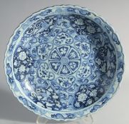 A LARGE CHINESE YUAN STYLE BLUE AND WHITE PORCELAIN CHARGER, painted with panels of phoenix and