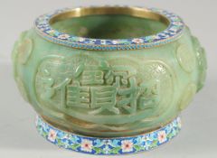 A CHINESE CARVED GREEN HARDSTONE BOWL with cloisonne banded rims, the exterior carved with immortals