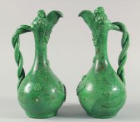 A PAIR OF 19TH CENTURY OTTOMAN TURKISH CANAKKALE GREEN GLAZED POTTERY EWERS, each approx. 34cm