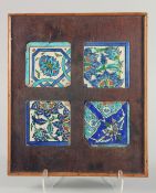 A SET OF FOUR FRAMED 18TH CENTURY IZNIK GLAZED POTTERY TILES, each with different foliate motifs