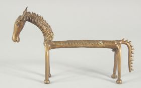 AN ISLAMIC BRASS FIGURE OF A STYLISED HORSE, 24.5cm long.