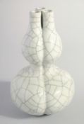 A CHINESE CRACKLE GLAZE DOUBLE GOURD THREE-NECK VASE, six-character mark to base, 21.5cm high.