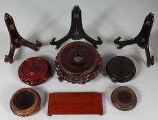 A COLLECTION OF NINE CHINESE HARDWOOD STANDS, various types / sizes, largest 16cm diameter, (9).