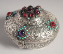 A SMALL TURKISH EMBOSSED AND CHASED SILVER BOX, the hinged lid inset with different beads