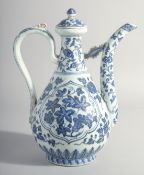 A CHINESE MING STYLE BLUE AND WHITE PORCELAIN LIDDED EWER, with floral decoration, 30.5cm high