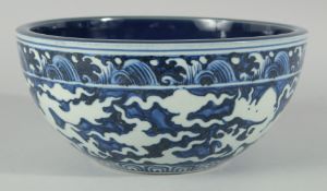 A CHINESE SACRIFICIAL BLUE AND WHITE BOWL, decorated with dragons to the exterior, the base with