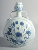 A CHINESE BLUE AND WHITE PORCELAIN TWIN HANDLE MOON FLASK, decorated with a central spray of