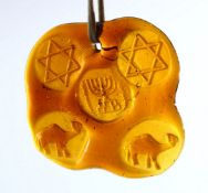 A JEWISH JUDAICA AMBER COLOUR GLASS HANGING / PENDANT - the glass impressed with related animals and