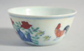 A CHINESE DOUCAI PORCELAIN CHICKEN CUP, six-character mark to base, 8cm diameter.