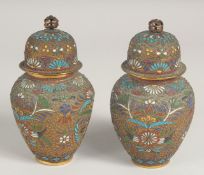 A PAIR OF CHINESE CLOISONNE JARS AND COVERS, decorated with various enamelled wire work floral