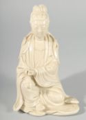 A 19TH/20TH CENTURY BLANC-DE-CHINE SEATED PORCELAIN FIGURE, the reverse with stamped character