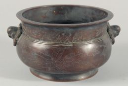 A LARGE CHINESE BRONZE TWIN HANDLE CENSER, the handles formed as stylised bird heads, the base