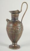 AN EARLY CLASSICAL BRONZE EWER, with a band of archaic style figures to the body, 35cm high.