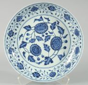 A CHINESE BLUE AND WHITE PORCELAIN CHARGER, decorated with flower heads and vine, 33.5cm diameter.