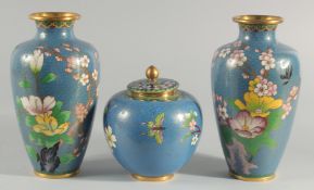 TWO CHINESE BLUE GROUND CLOISONNE VASES, and a similar jar with associated cover, vases 23.5cm high,