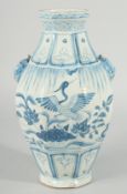 A CHINESE OCTAGONAL BLUE AND WHITE TWIN HANDLE VASE, with moulded lion heads as handles, the body