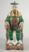 A CHINESE SANCAI POTTERY FIGURE of a seated dignitary, 22cm high.