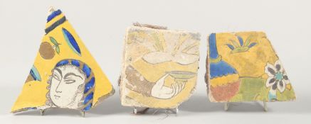 THREE 17TH CENTURY PERSIAN SAFAVID TILE FRAGMENTS, largest 14cm x 15cm.