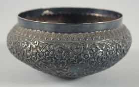 A SMALL INDIAN SILVER BOWL, with embossed floral decoration, 13.5cm diameter.