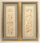 A PAIR OF 20TH CENTURY CHINESE EMBROIDERED SILK PANELS, with flora, birds and butterflies, framed