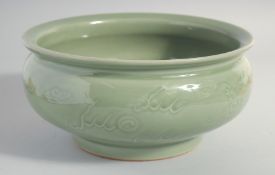 A LARGE CHINESE CELADON GLAZE BOWL, carved with dragon and the flaming pearl of wisdom, 25.5cm