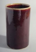 A CHINESE IRON RED GLAZE CYLINDRICAL BRUSH POT, 15cm high.