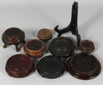 A COLLECTION OF NINE CHINESE HARDWOOD STANDS, various types / sizes, largest 13.5cm diameter, (9).