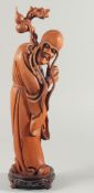 A LARGE CARVED WOOD FIGURE OF AN IMMORTAL, mounted to a carved and pierced hardwood base, 46.5cm