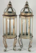 A PAIR OF CIRCULAR COPPER AND GLASS LANTERNS 32ins high.