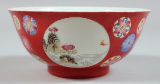 A CHINESE PORCELAIN BOWL decorated with panels of figures and birds. 5.75ins diameter.