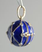 A SILVER AND ENAMEL BLUE BALL LOCKET.