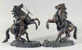 A GOOD PAIR OF BRONZE MARLEY HORSES AND ATTENDANTS. 11ins high.