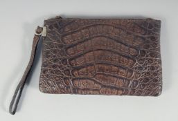 A 1940's - 1950's BROWN CROCODILE SKIN HANDBAG with raised skin, fitted interior with a purse. 8.