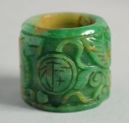 A CHINESE CARVED JADE ARCHER'S RING. 1.5ins