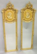 A PAIR OF DECORATIVE GILTWOOD TALL MIRRORS, the upper section with the bust of a lady.5ft 10ins high