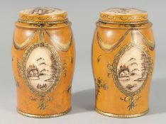 A PAIR OF ORANGE TOLEWARE TEA TINS AND COVERS. 6.5ins high.