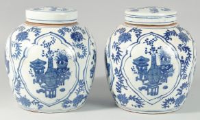 A LARGE PAIR OF CHINESE BLUE AND WHITE GINGER JARS AND COVERS. 10ins long.