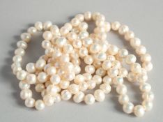 A LONG STRING OF WHITE PEARLS.