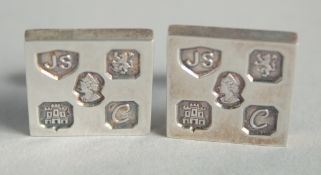 A PAIR OF SILVER MARK CUFF LINKS.