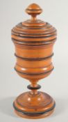A TURNED WOOD CIRCULAR CHALICE AND COVER. 10ins high.