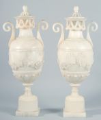 A VERY GOOD PAIR OF 19TH CENTURY FRENCH ALABASTER, TWO HANDLED URNS AND COVERS, carved with garlands