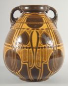 A GOOD SECESSIONIST TWO HANDLED POTTERY VASE. 14ins high.